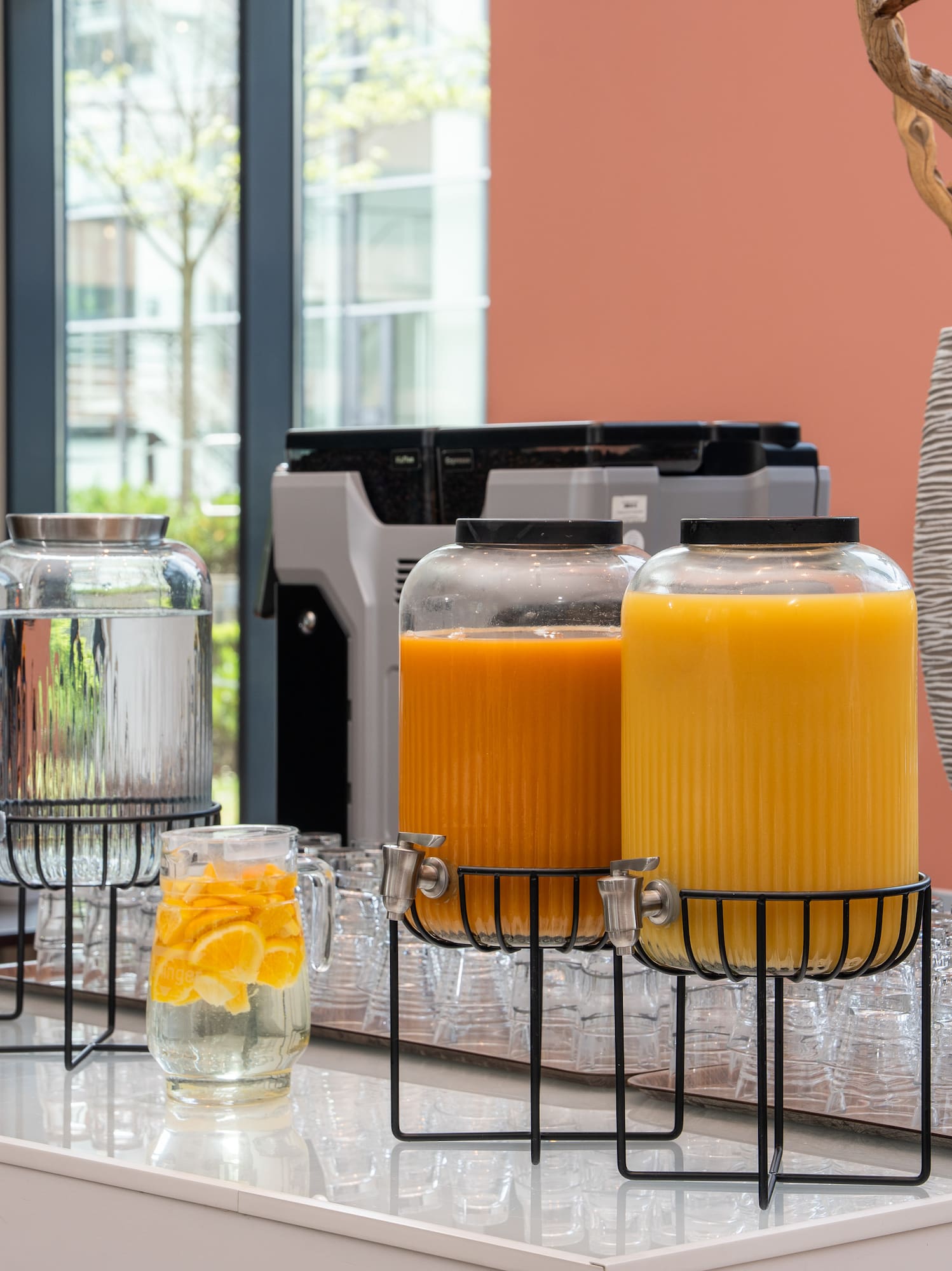 a group of glasses with orange liquid in them