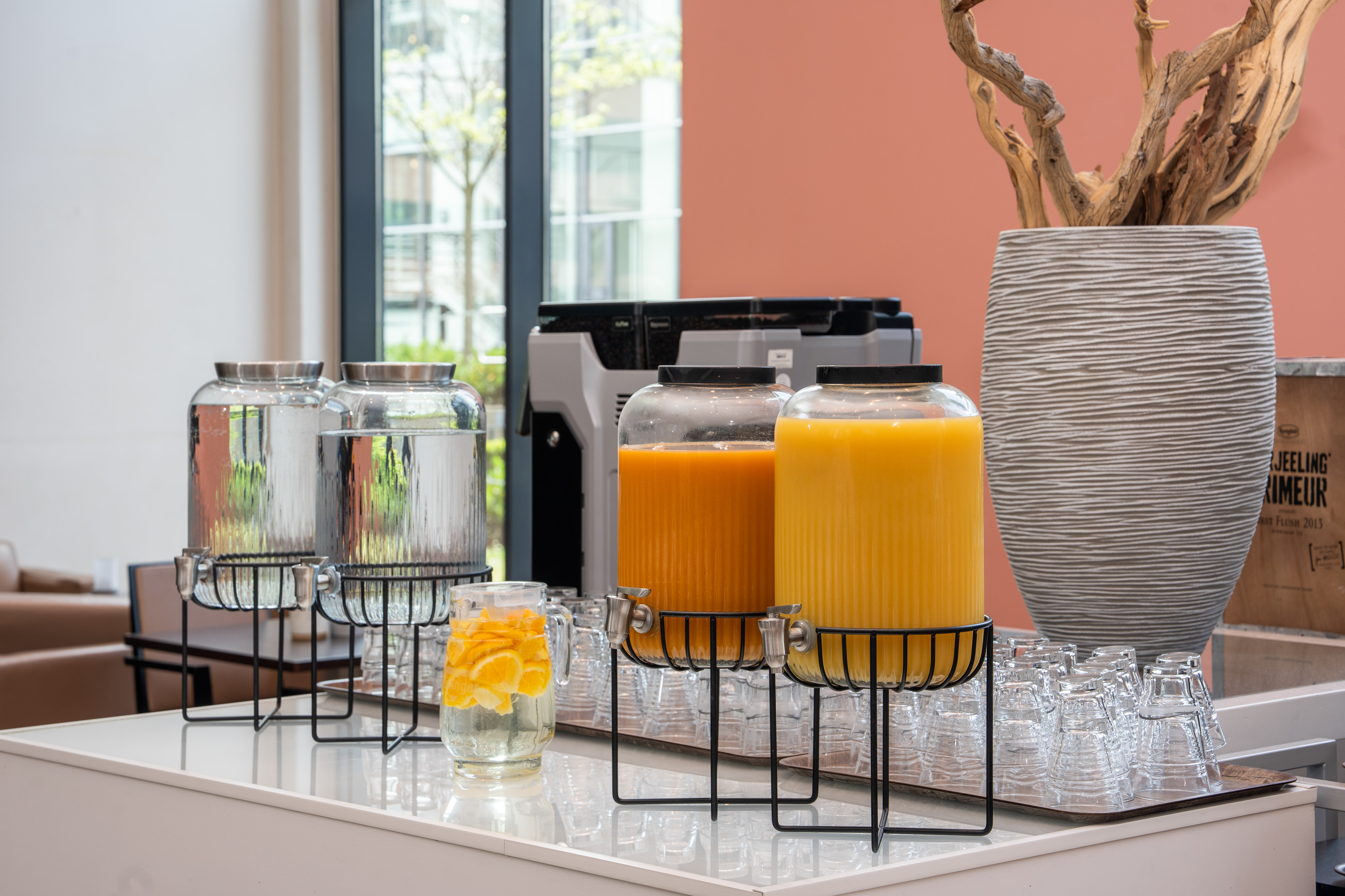 a group of glasses with orange liquid in them