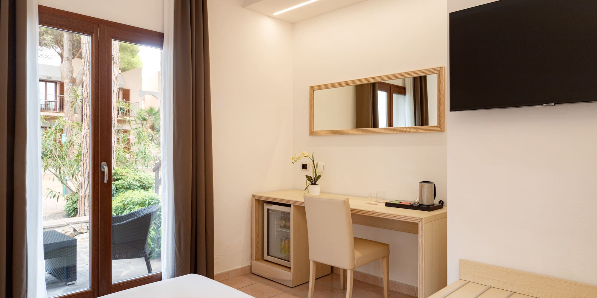 a room with a bed and a mirror