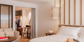 a bedroom with a bed and a chair