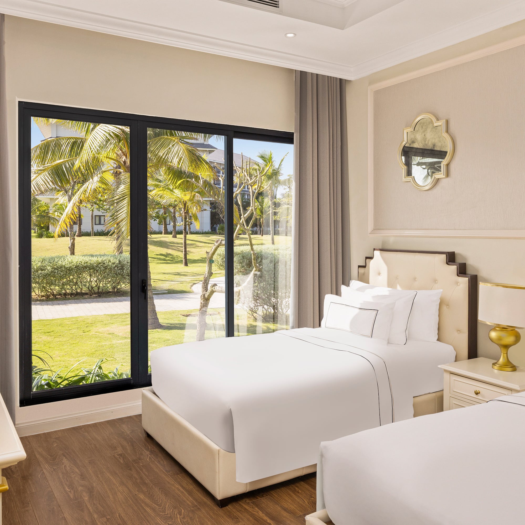 a bedroom with two beds and a glass door