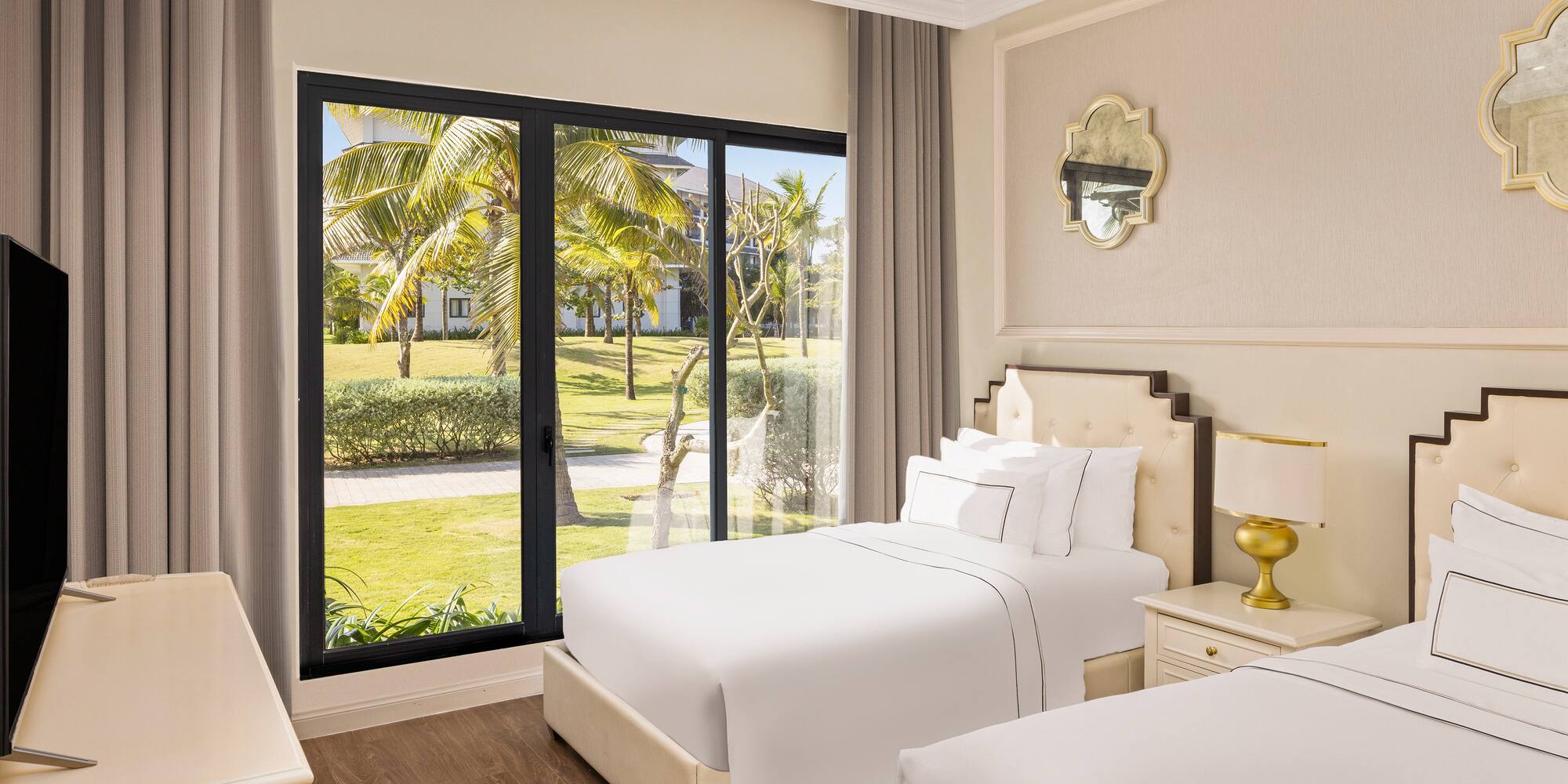 a bedroom with two beds and a glass door