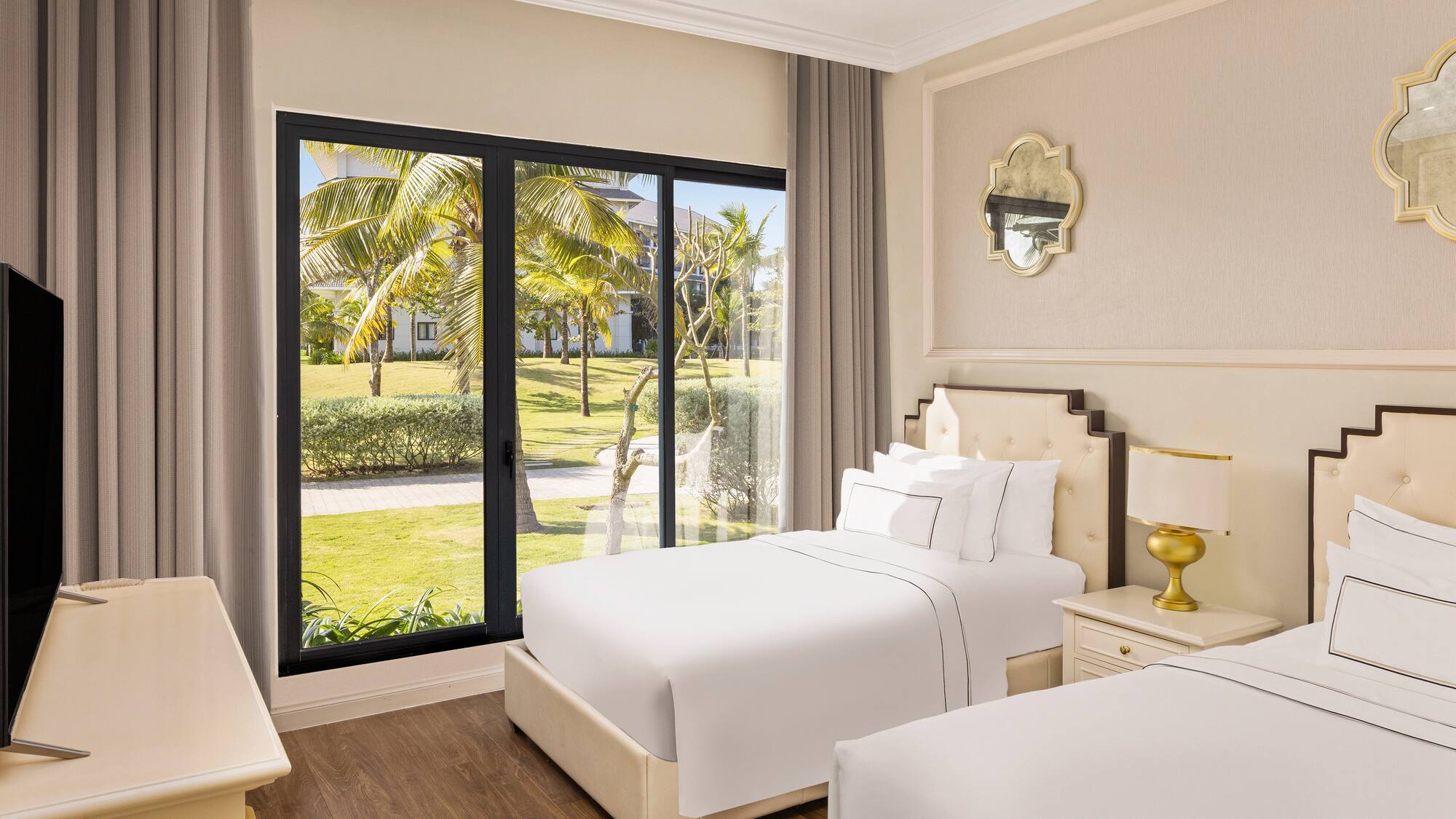 a bedroom with two beds and a glass door