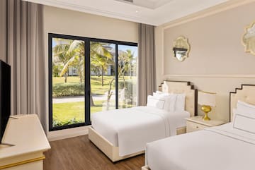 a bedroom with two beds and a glass door