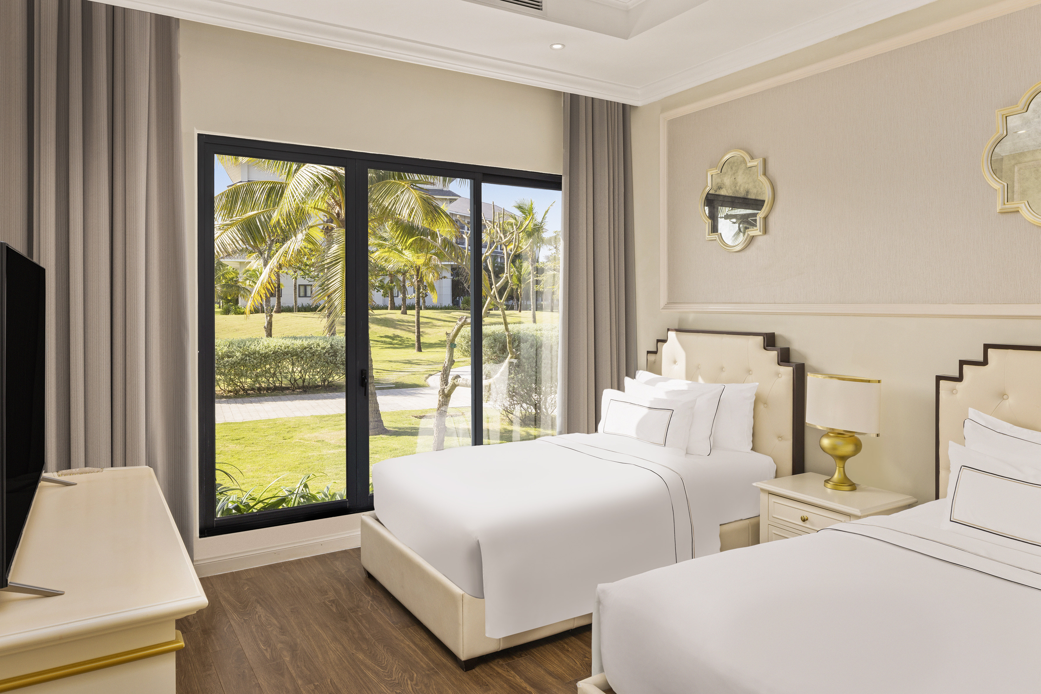 a bedroom with two beds and a glass door