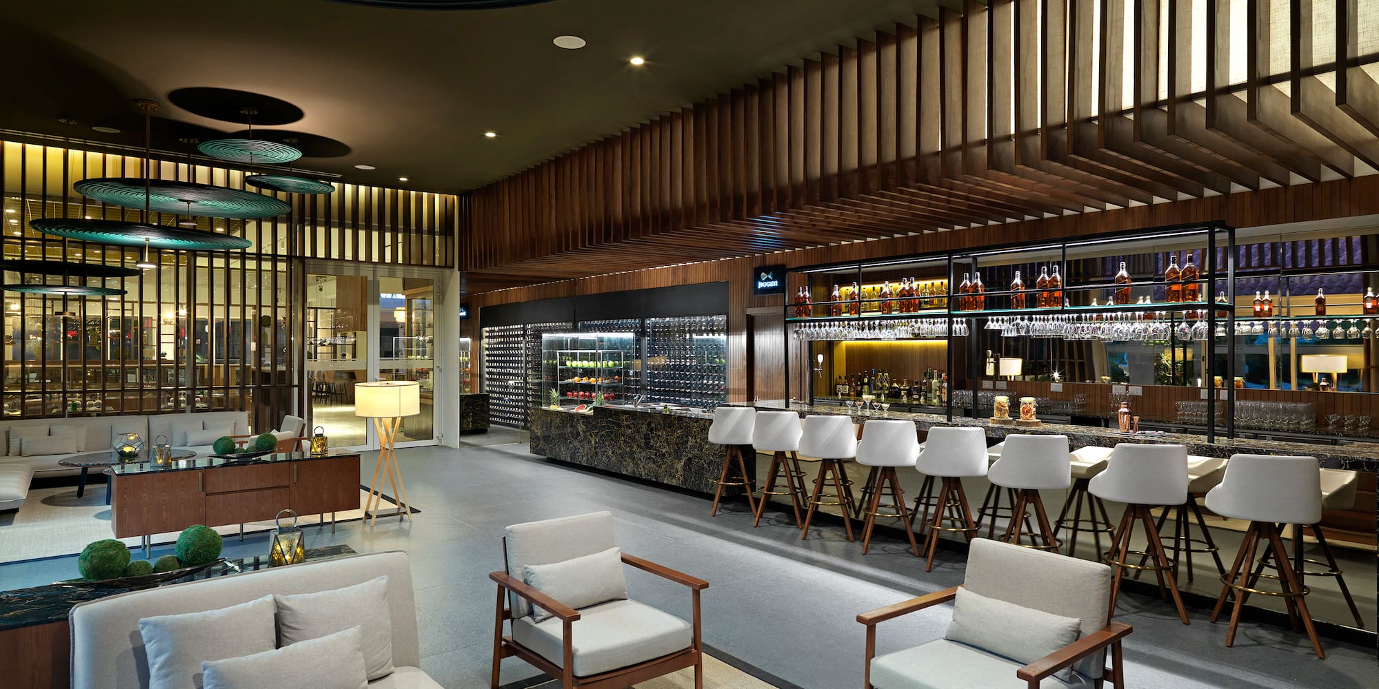 a room with a bar and chairs