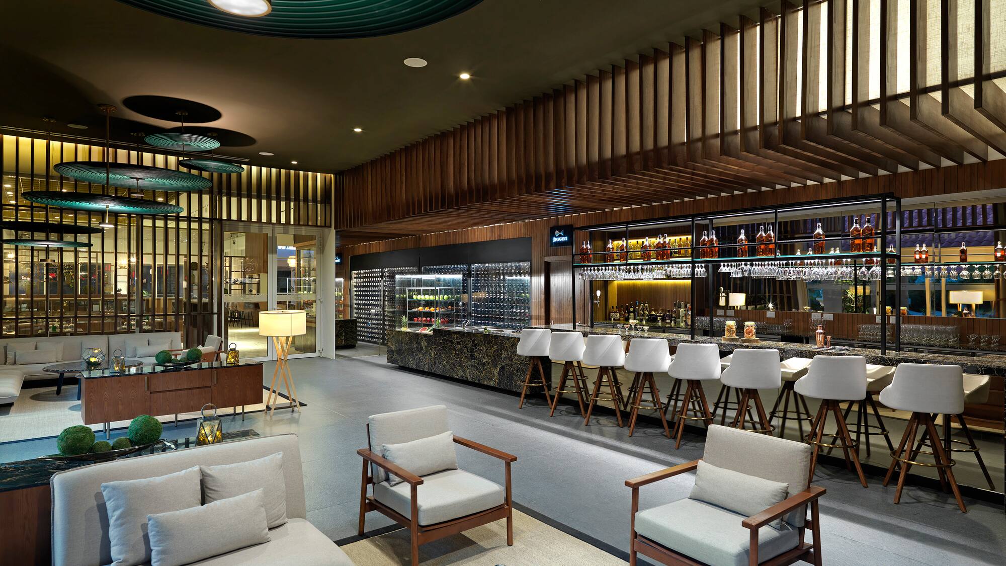 a room with a bar and chairs