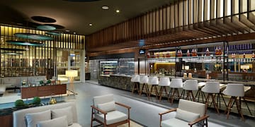 a room with a bar and chairs