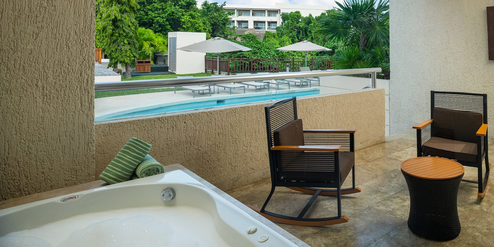 a jacuzzi with a hot tub and chairs