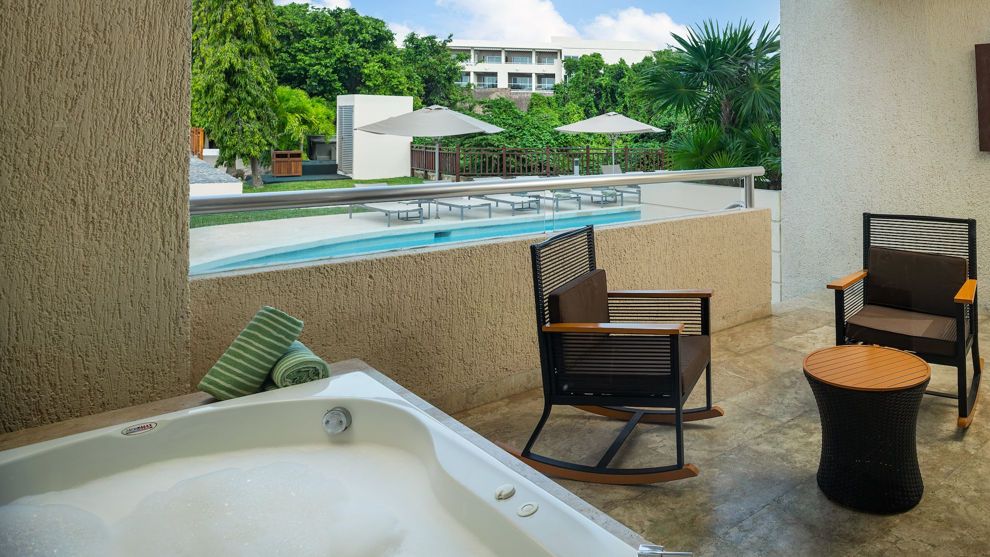 a jacuzzi with a hot tub and chairs