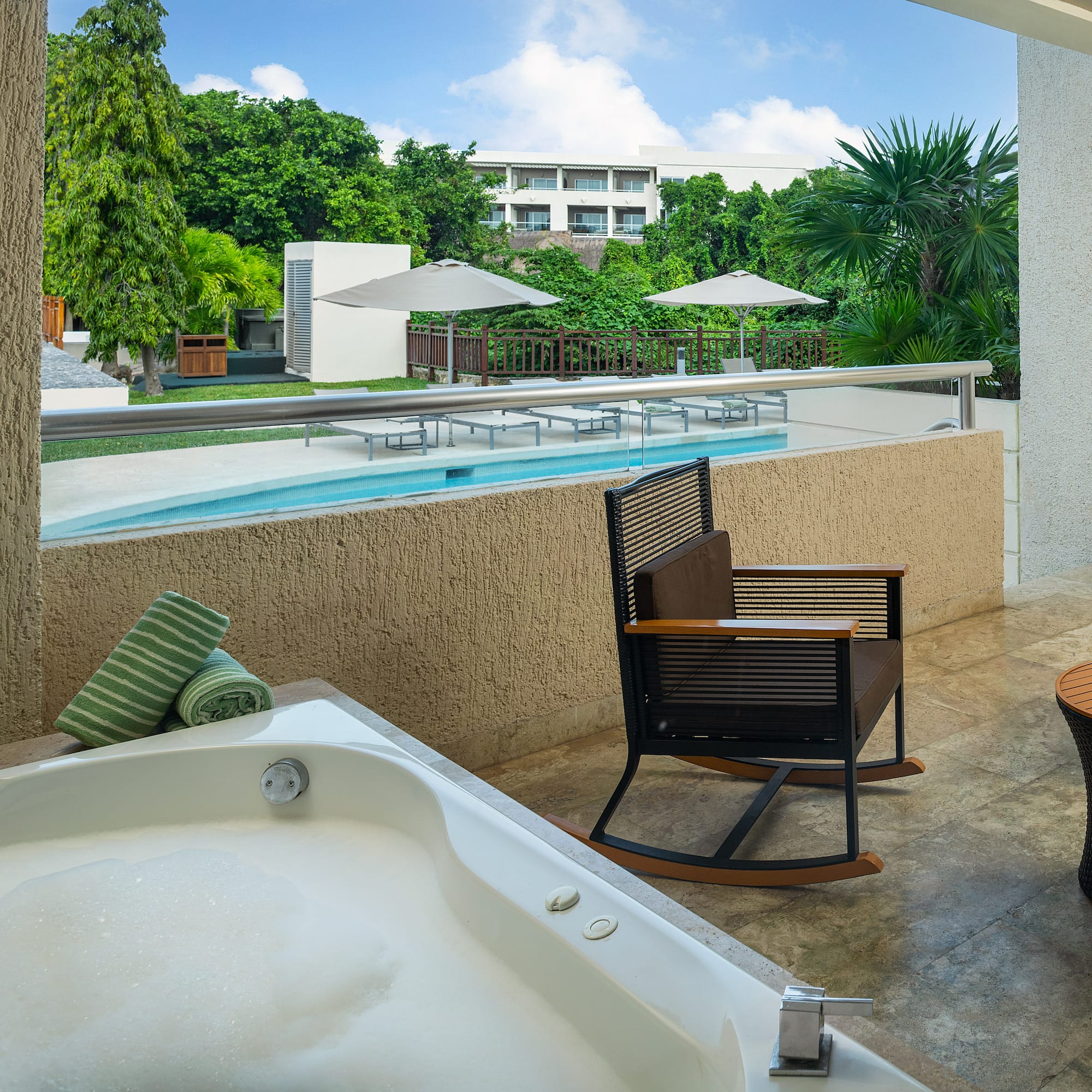 a jacuzzi with a hot tub and chairs