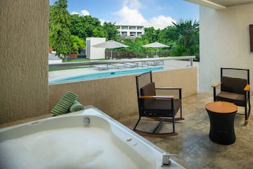 a jacuzzi with a hot tub and chairs