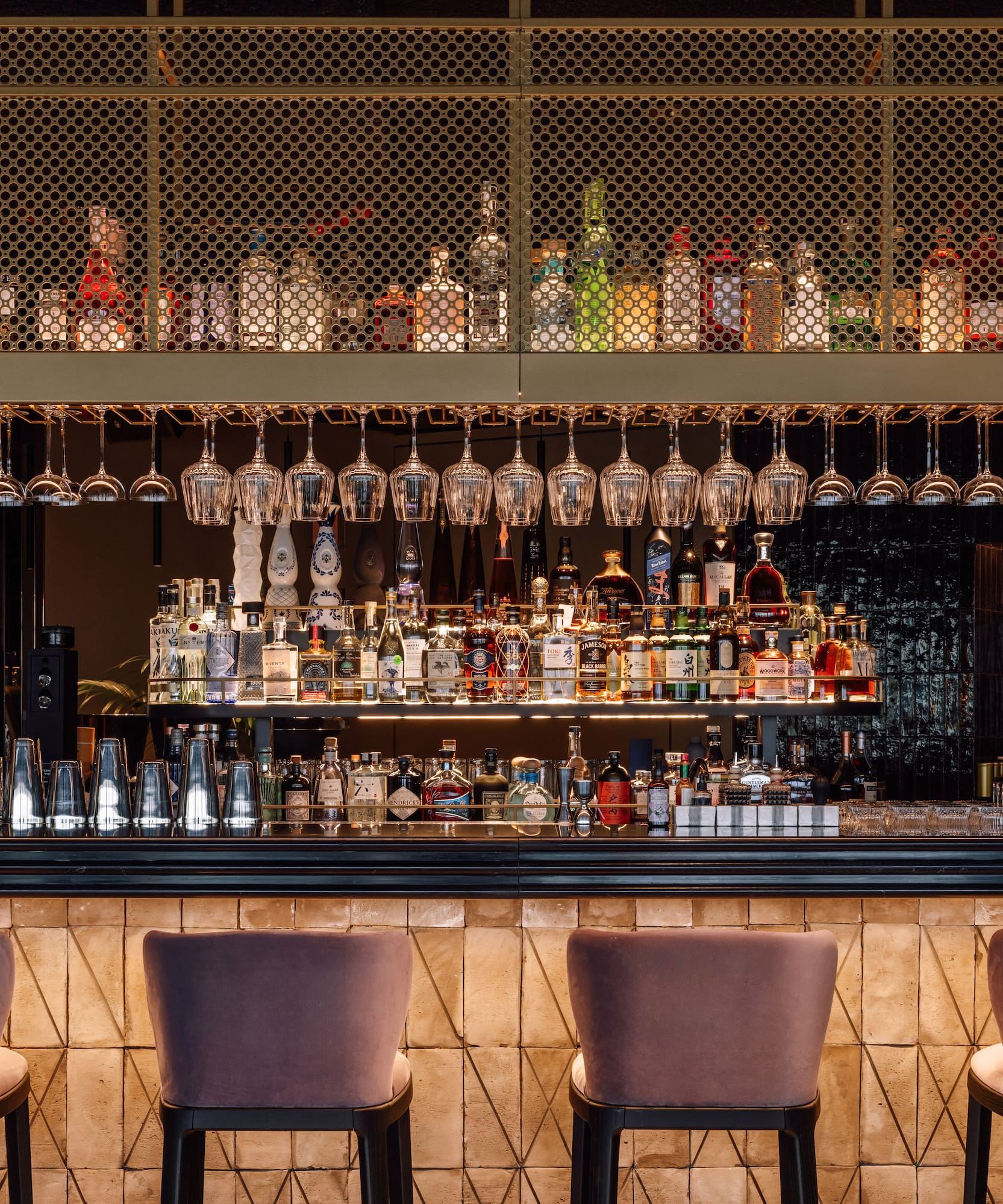 a bar with wine glasses from the ceiling