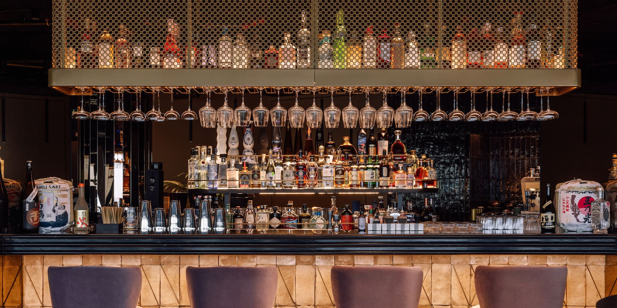 a bar with wine glasses from the ceiling