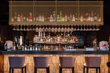 a bar with wine glasses from the ceiling