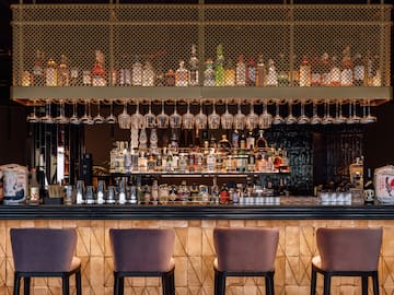 a bar with wine glasses from the ceiling