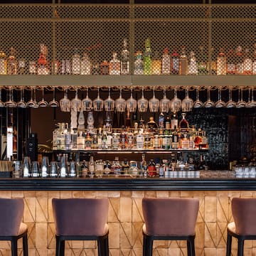 a bar with wine glasses from the ceiling