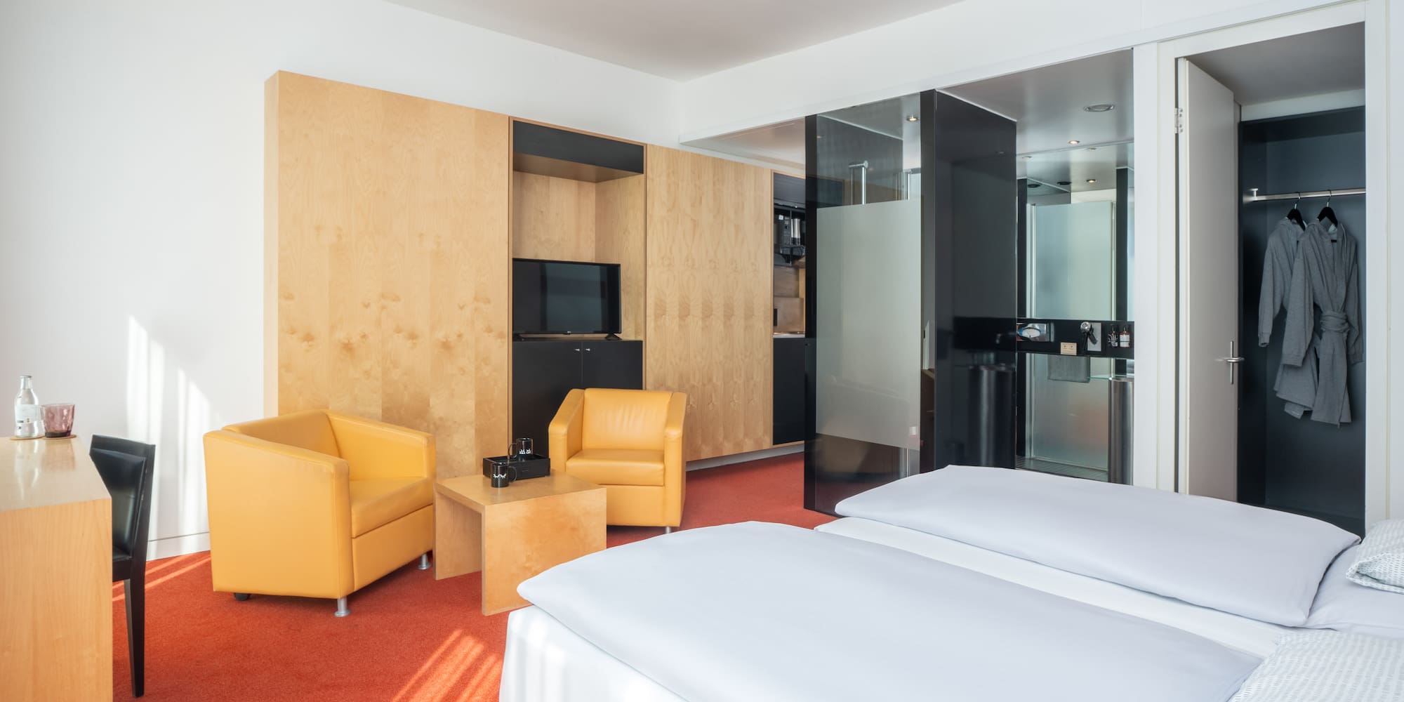 a room with two beds and a tv