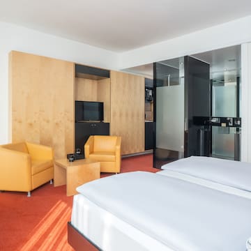 a room with two beds and a tv