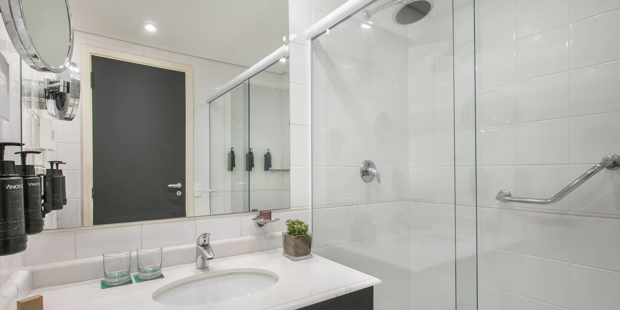 a bathroom with a glass shower and sink