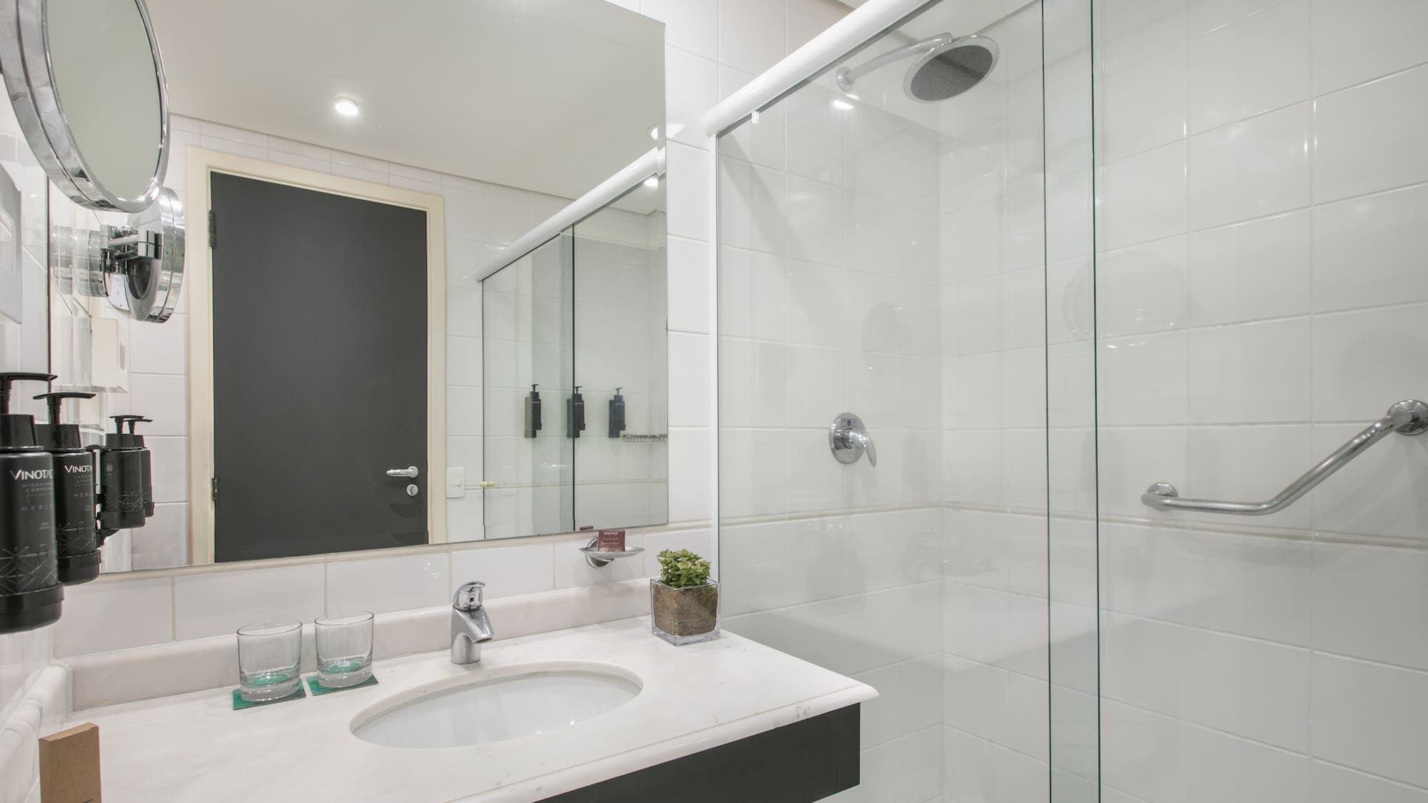 a bathroom with a glass shower and sink