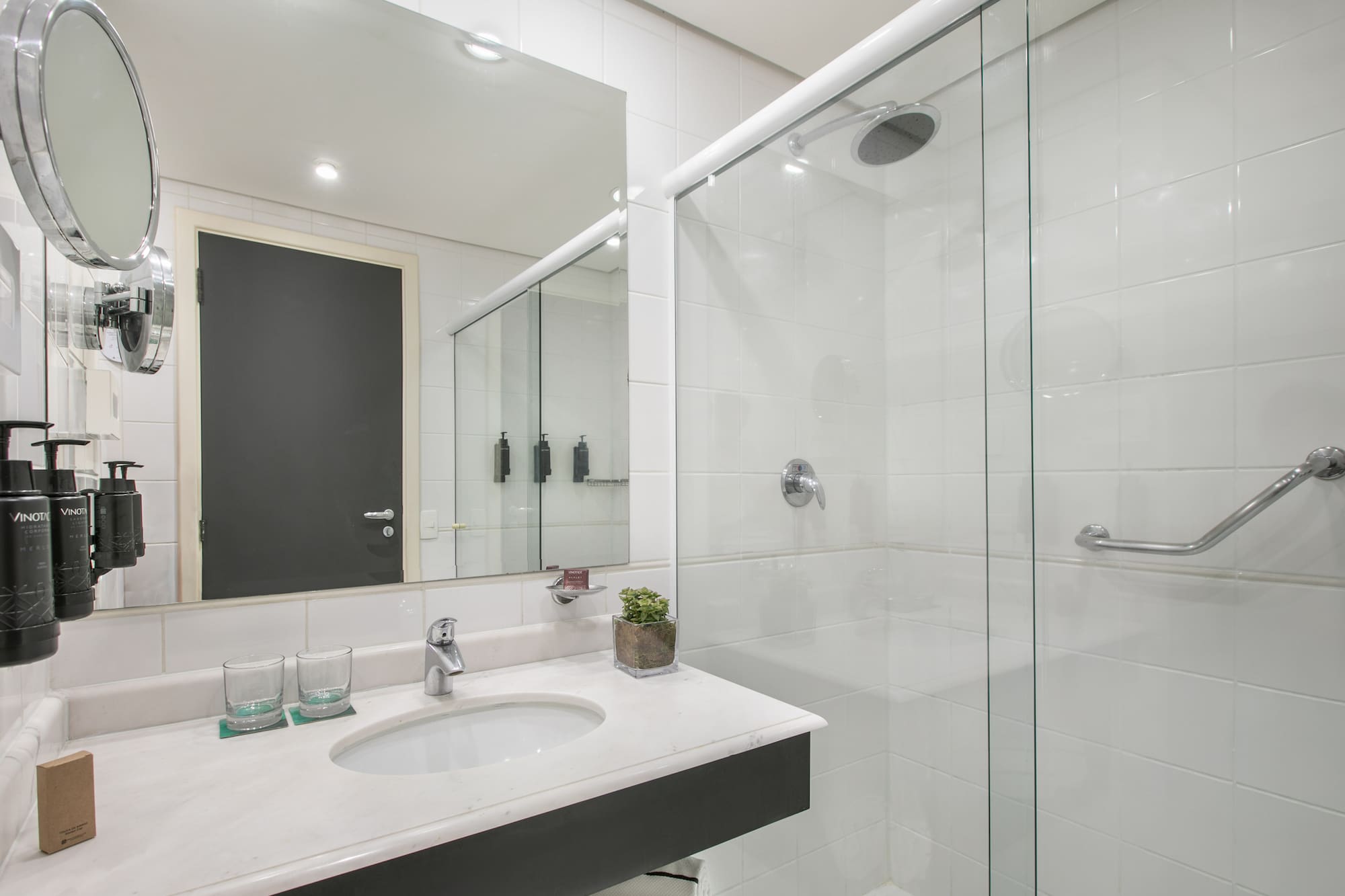 a bathroom with a glass shower and sink
