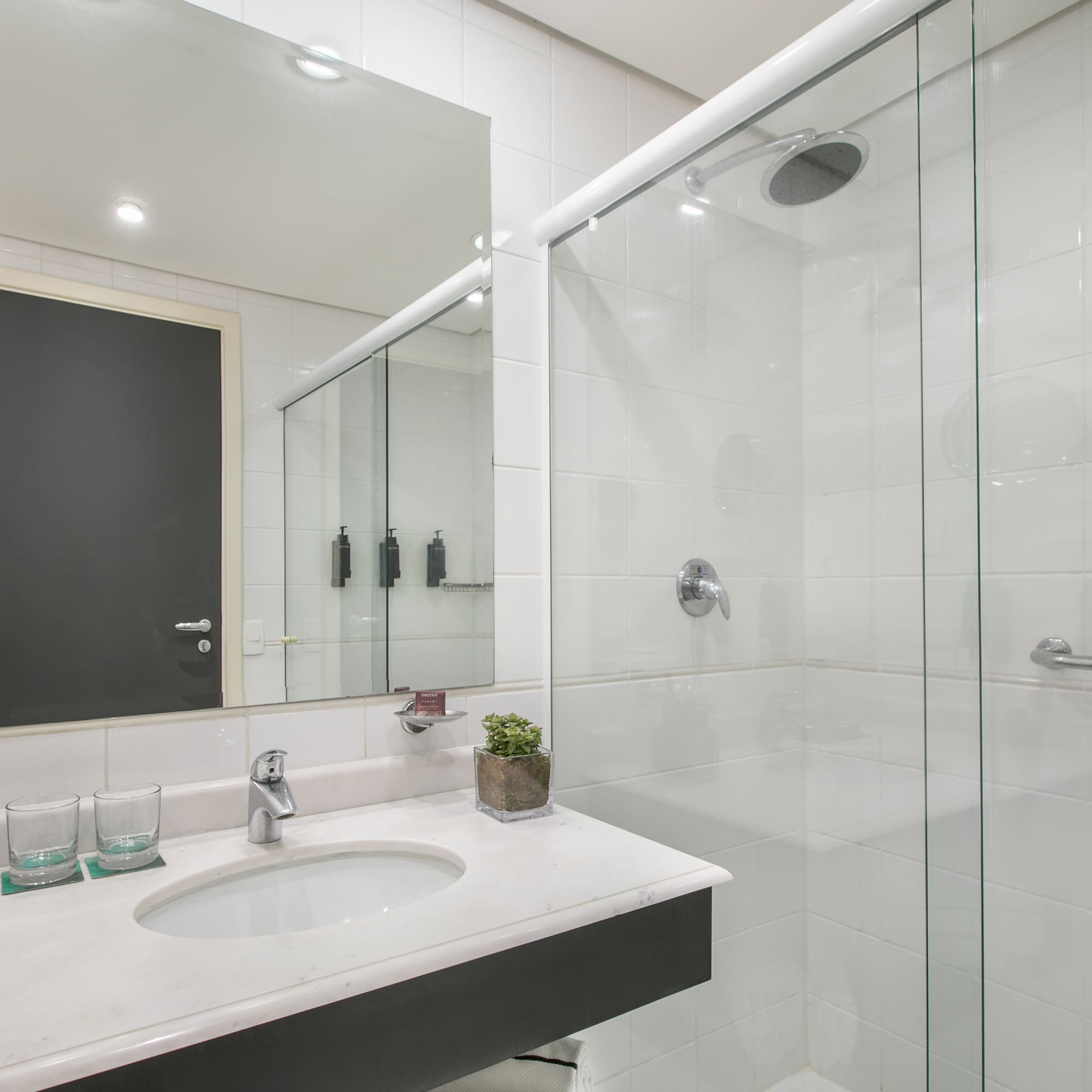 a bathroom with a glass shower and sink