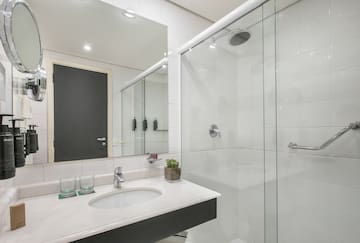 a bathroom with a glass shower and sink