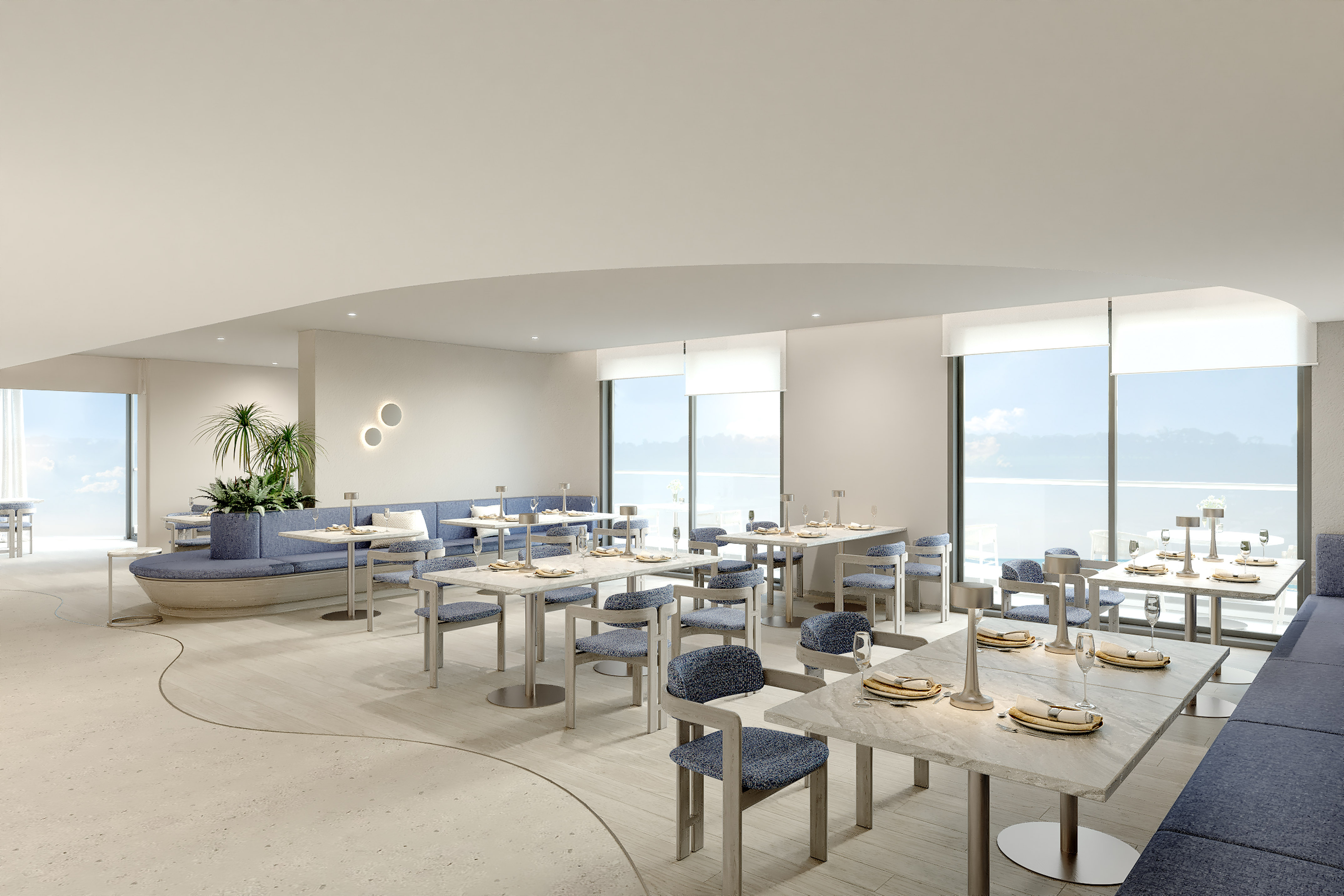 Contemporary restaurant with blue seating, marble tables, and ocean view.
