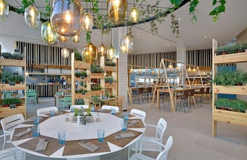 a room with tables and chairs and a chandelier