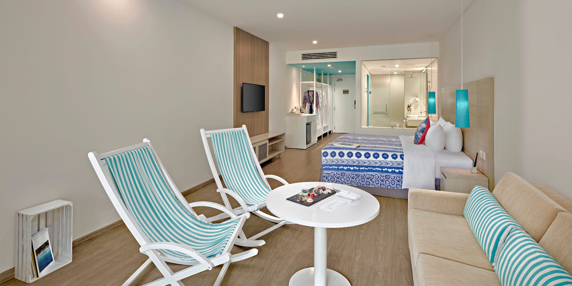 a room with a bed and chairs