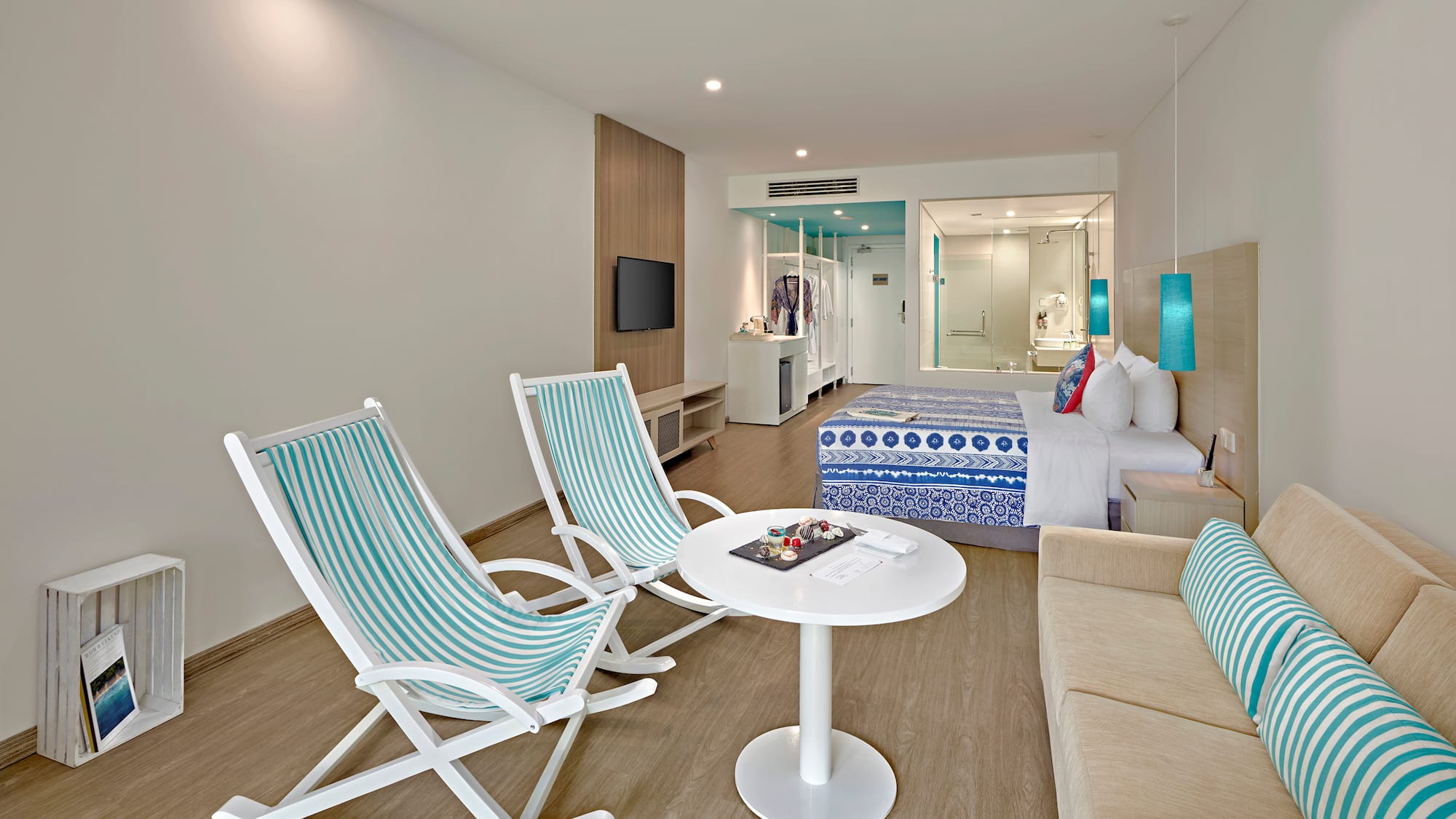 a room with a bed and chairs