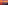 Fiery sunset over a red ocean, dark rocky cliff along the coast.