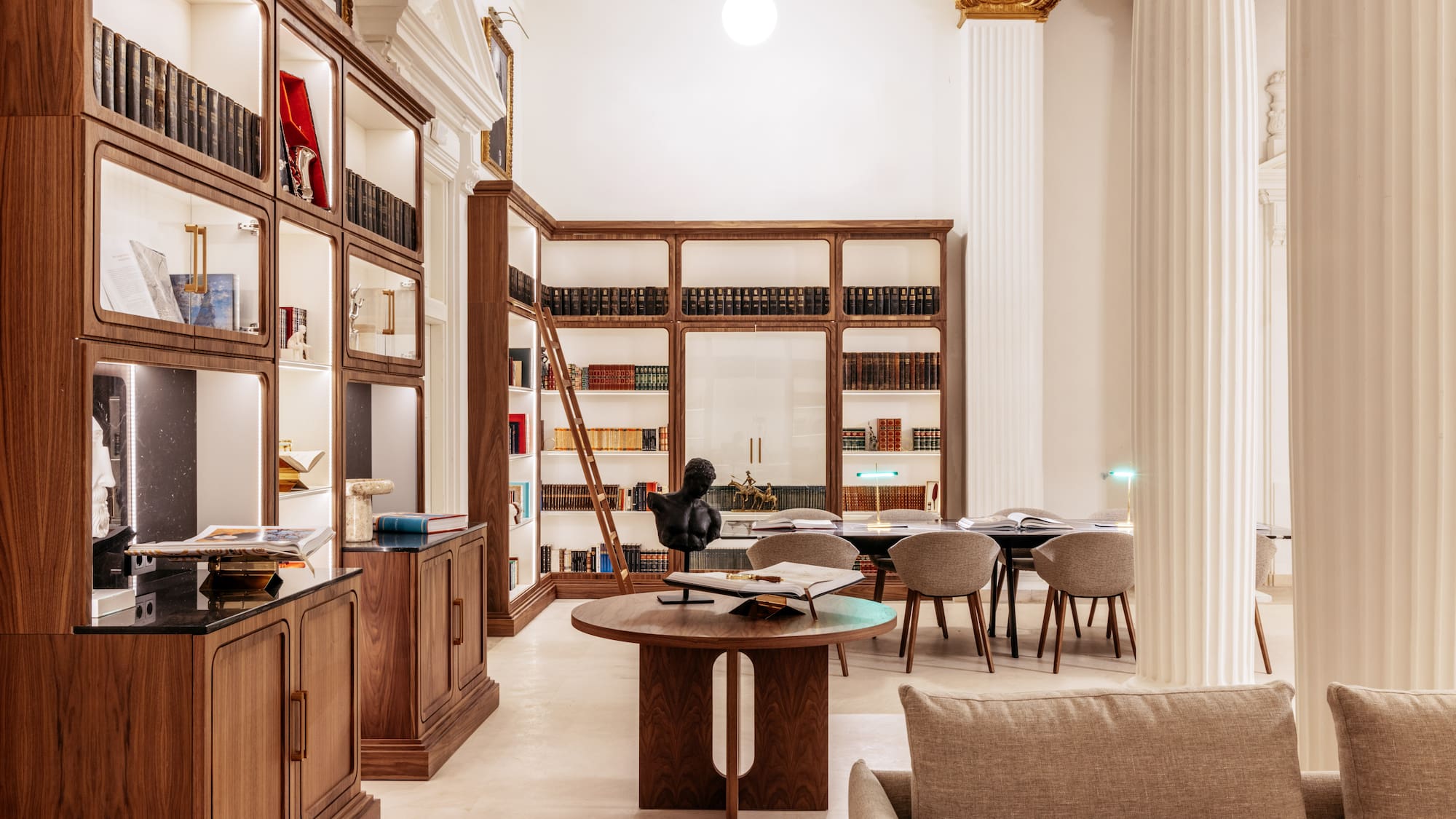 a room with a table and chairs and a bookcase