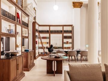 a room with a table and chairs and a bookcase