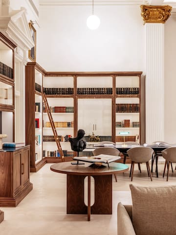 a room with a table and chairs and a bookcase