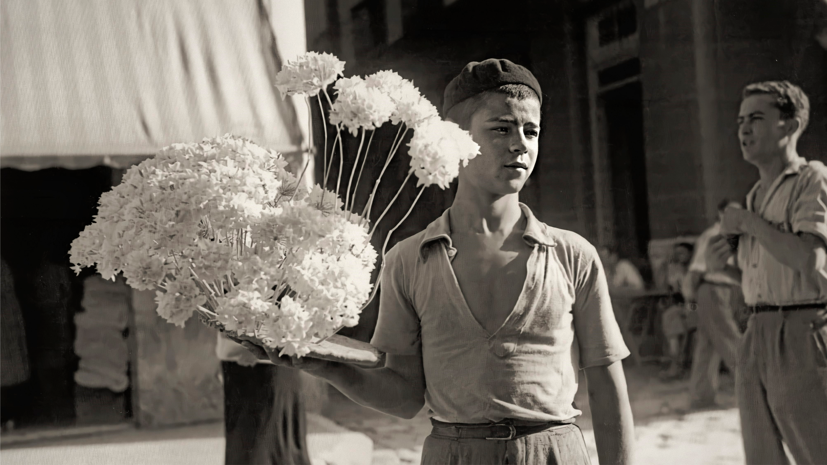 a boy holding flowers in his hand