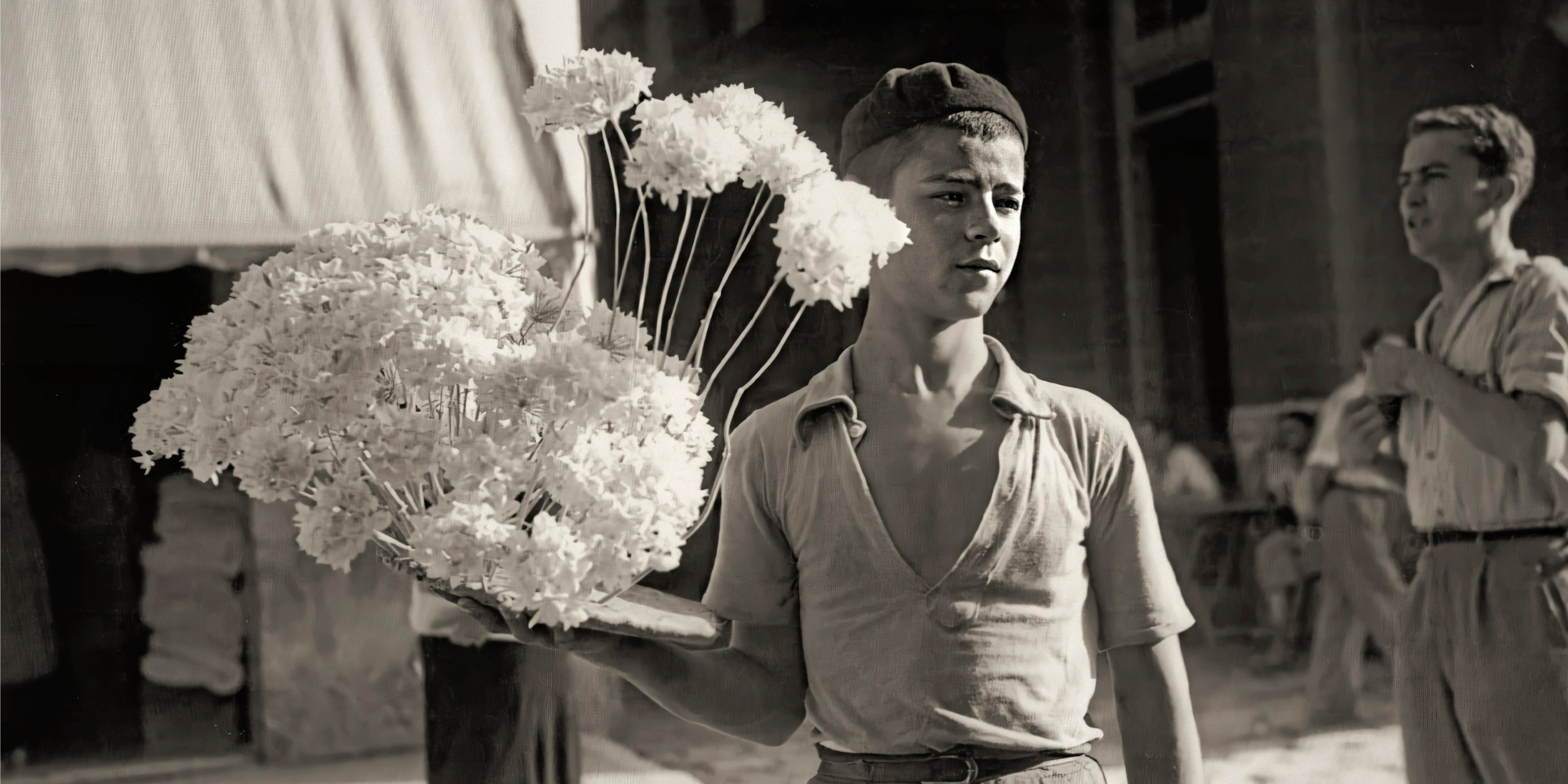 a boy holding flowers in his hand