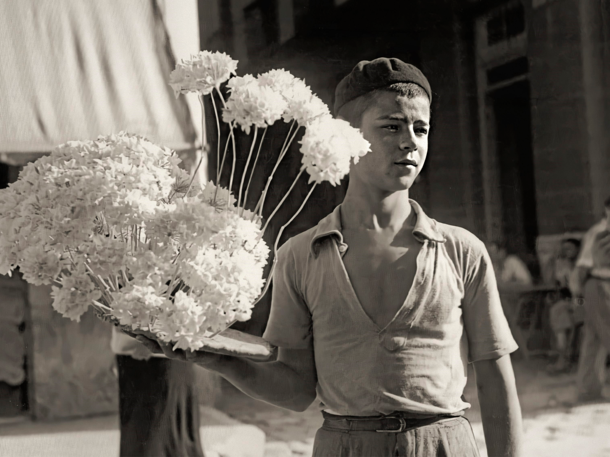 a boy holding flowers in his hand