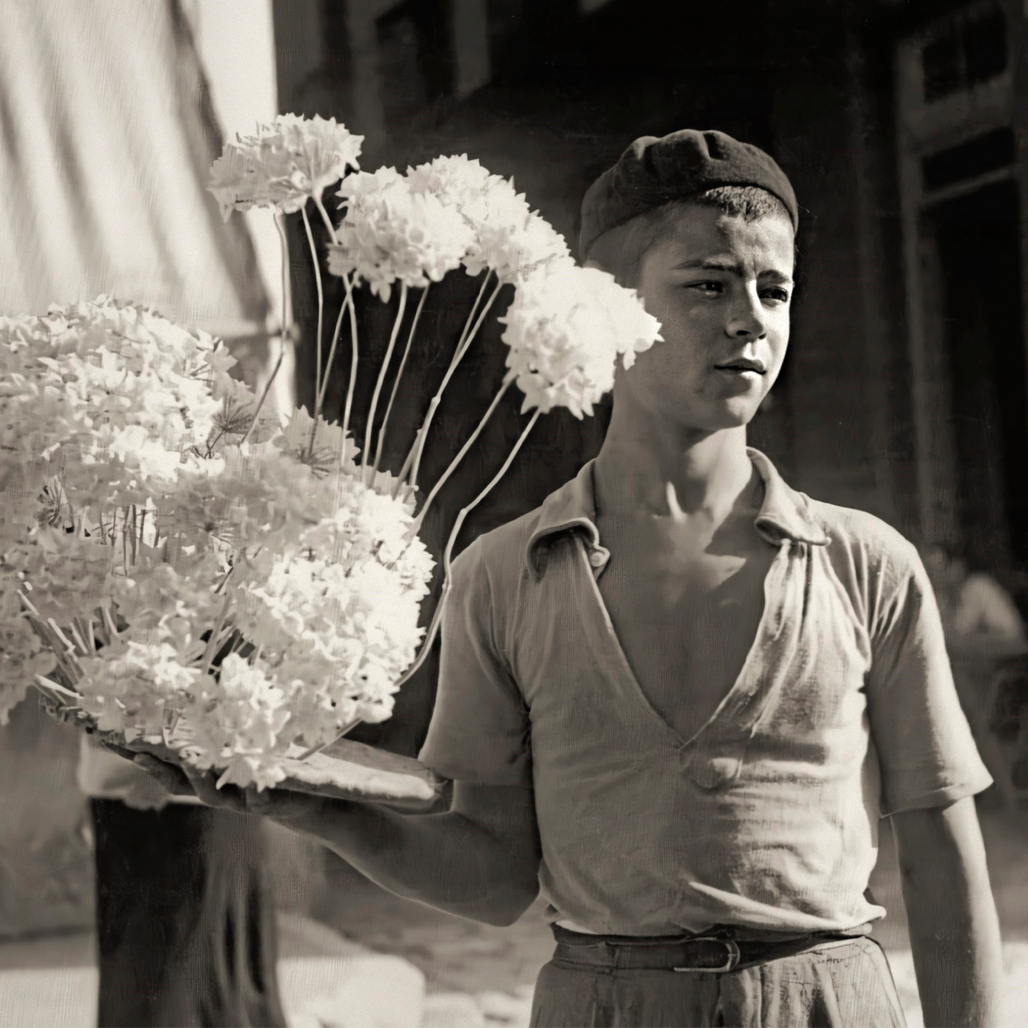 a boy holding flowers in his hand