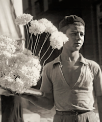 a boy holding flowers in his hand