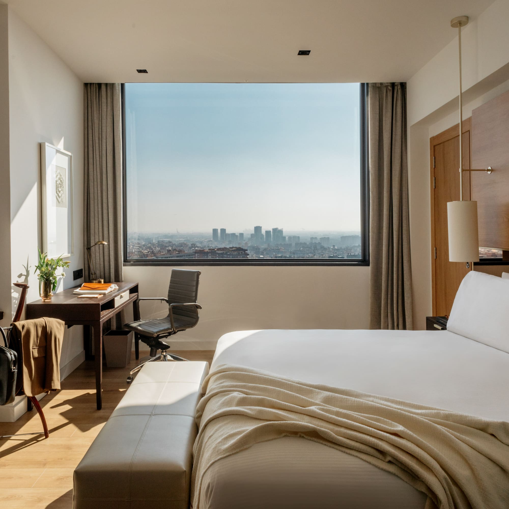 a bedroom with a desk and a bed