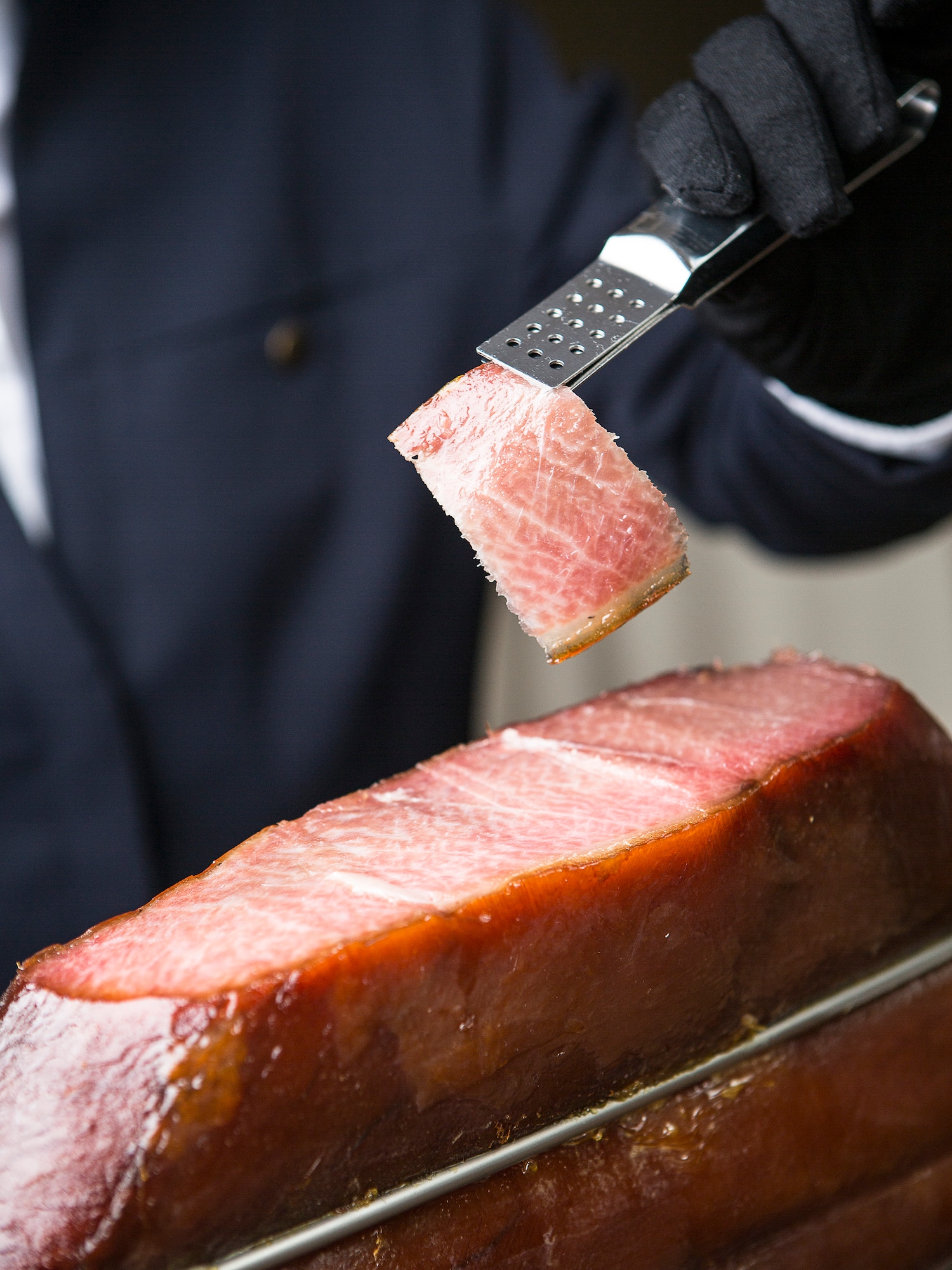 a person holding a piece of meat