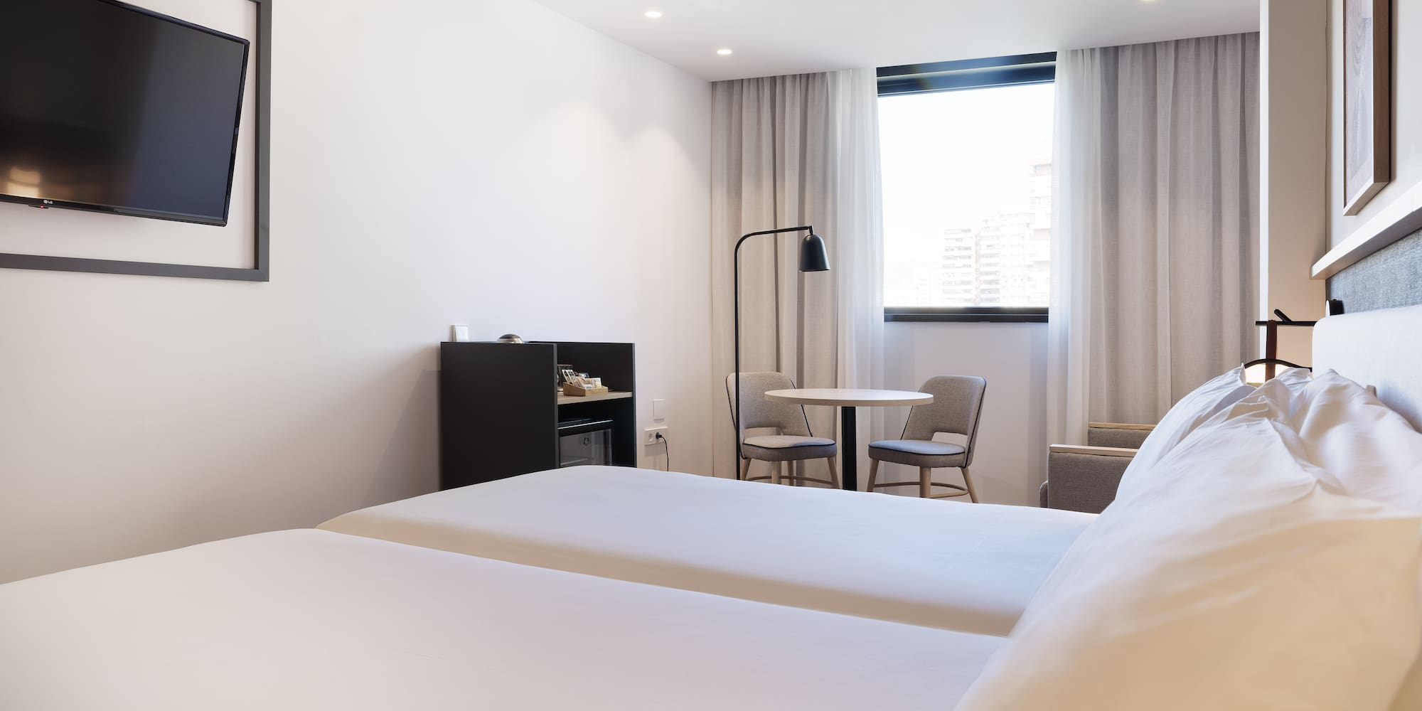 a room with two beds and a table