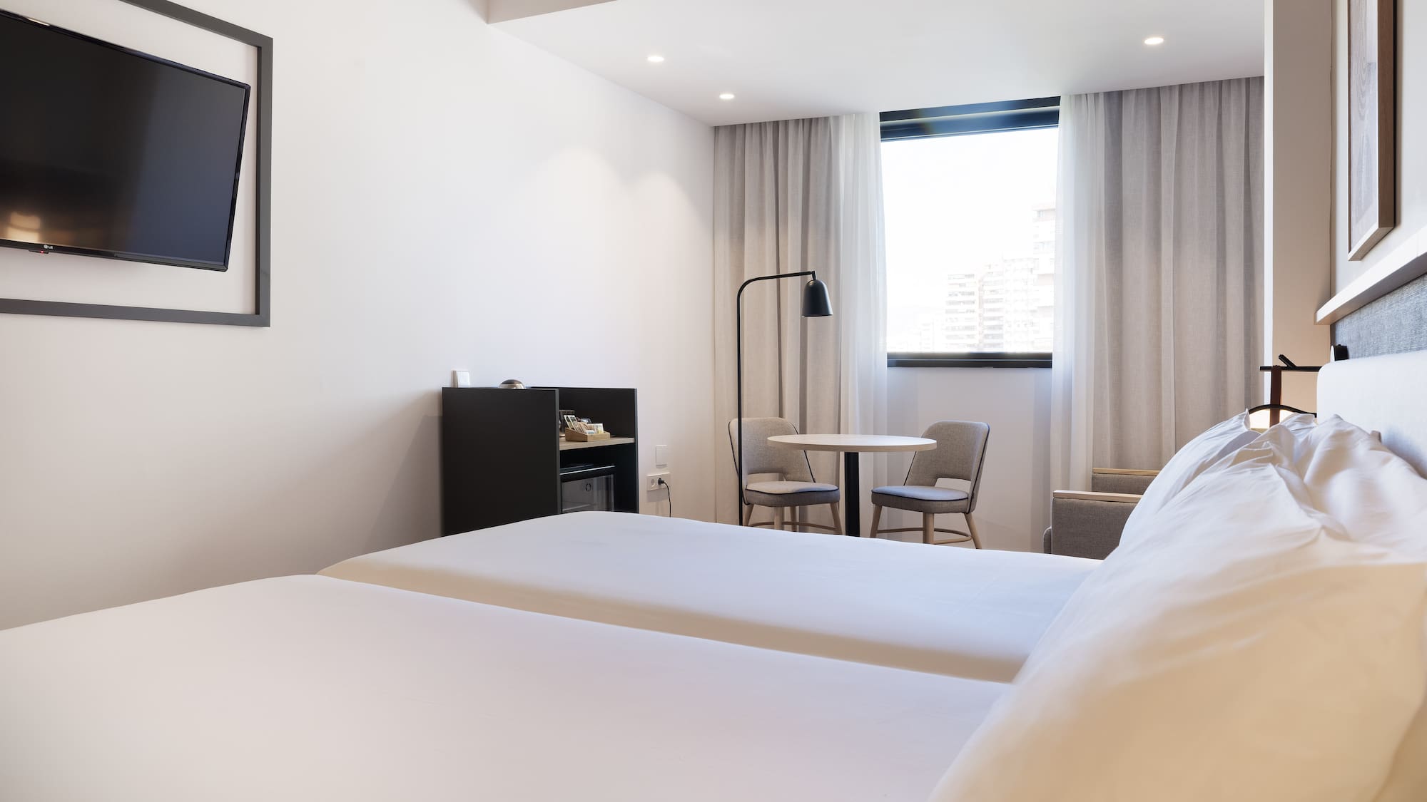 a room with two beds and a table