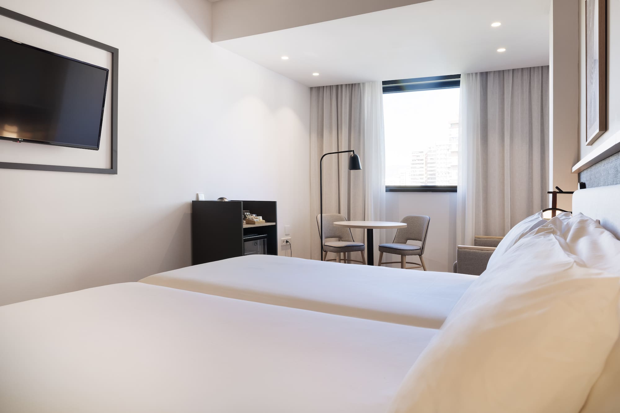 a room with two beds and a table