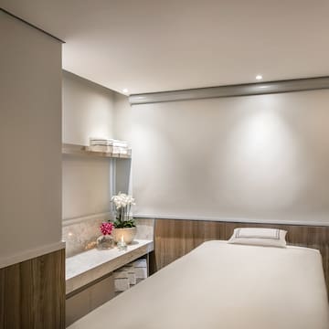 a massage room with a white board