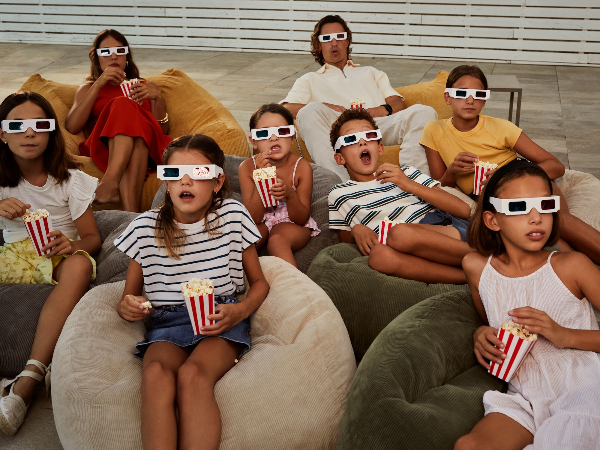 a group of people eating popcorn and wearing 3d glasses