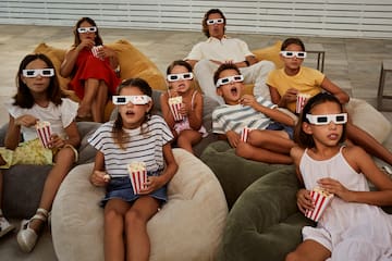 a group of people eating popcorn and wearing 3d glasses