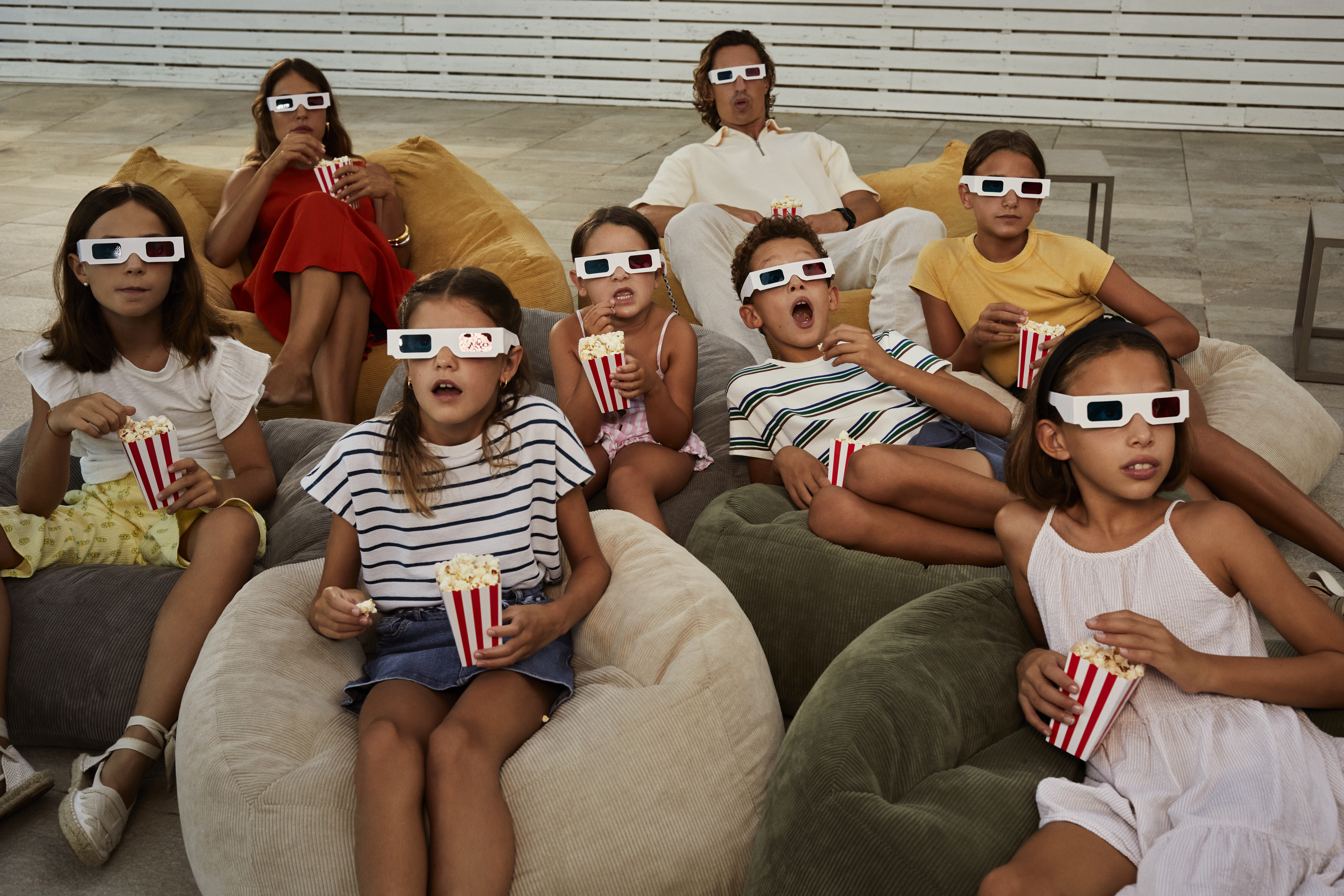 a group of people eating popcorn and wearing 3d glasses